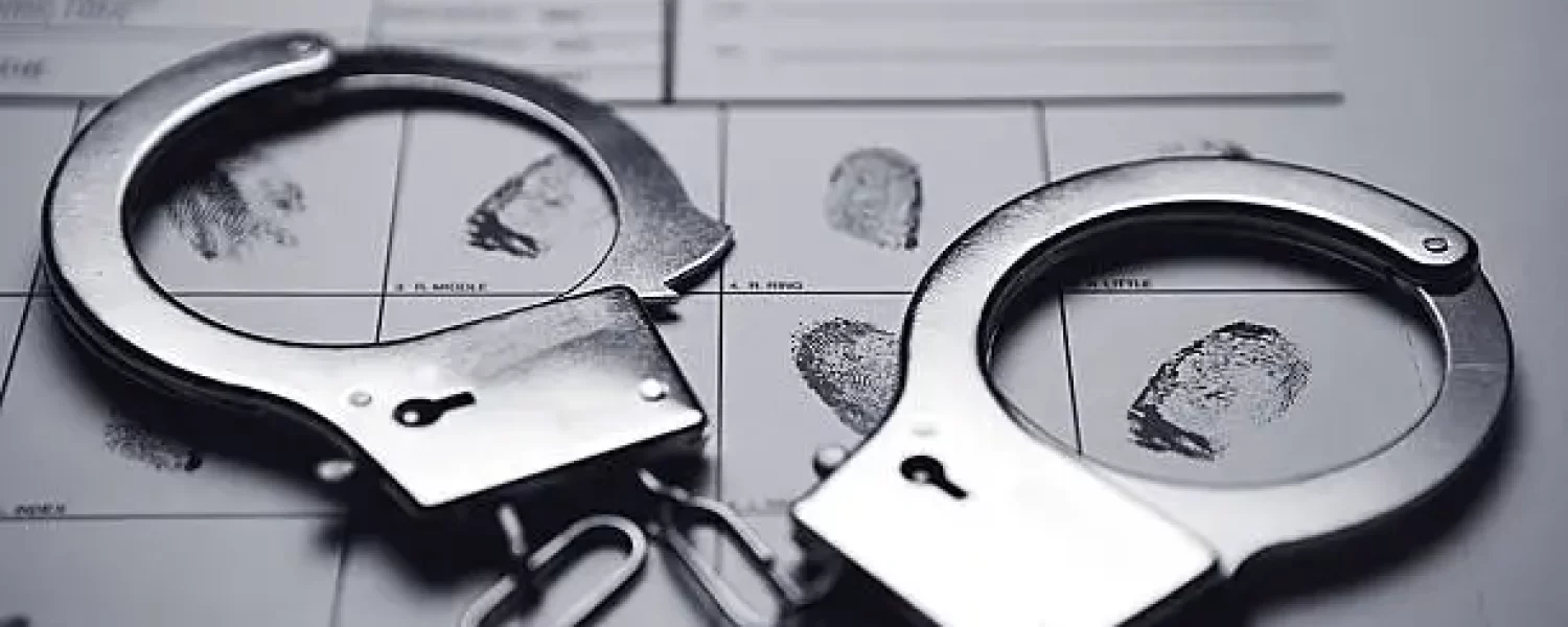 Handcuffs on top of a fingerprint form.
